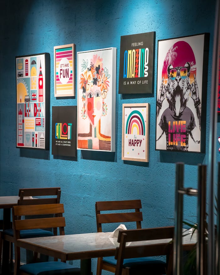 services-01 Vibrant wall art display enhances a cozy cafe interior, perfect for design inspiration.