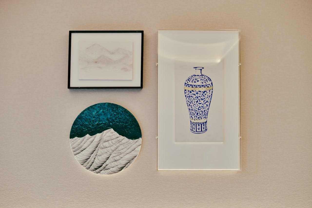 about-us-01 A collection of framed minimalist art on a textured wall, perfect for home decor.